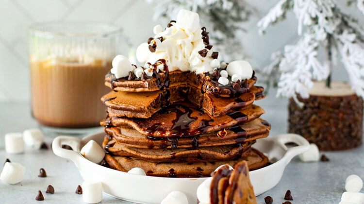 fluffy hot cocoa pancakes on a plate with marshmallows