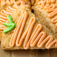 up close picture of picture of carrot cake scones with icing