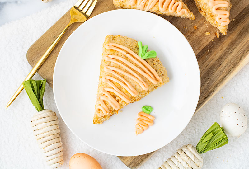 picture of carrot cake scones with icing on a plate