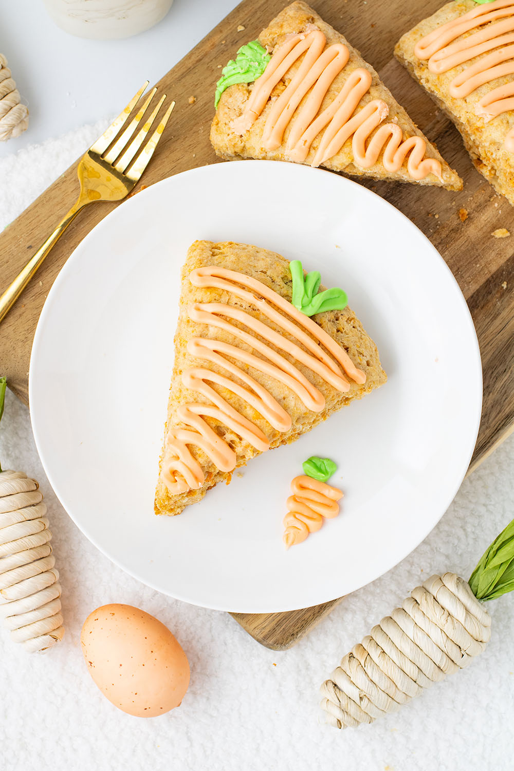 picture of carrot cake scones with icing on a plate