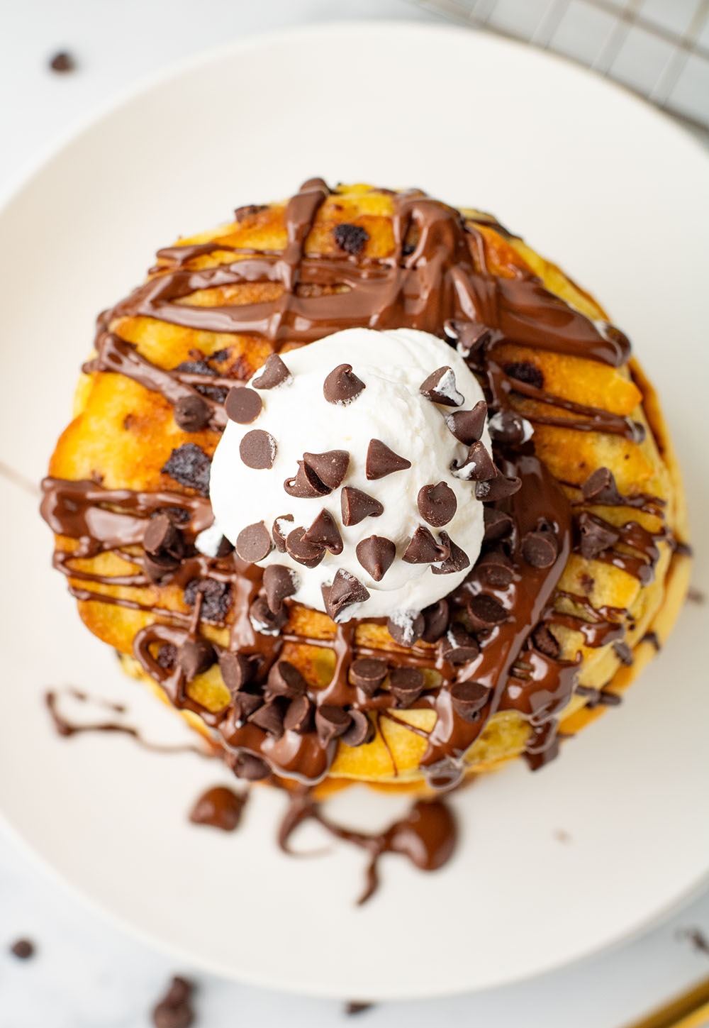 picture of Chocolate Chip Pancakes with delightful chocolate sauce, chips, and fluffy cream