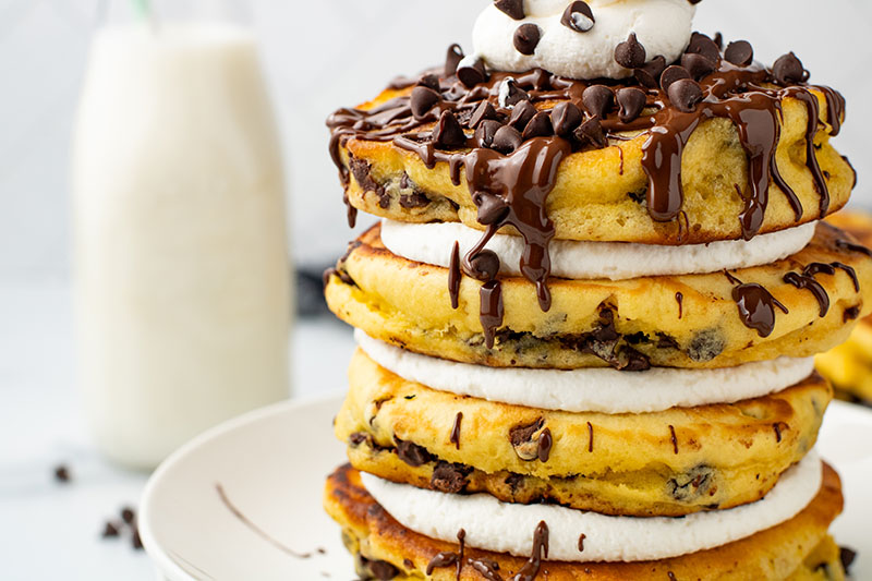 picture of Chocolate Chip Pancakes with delightful chocolate sauce, chips, and fluffy cream